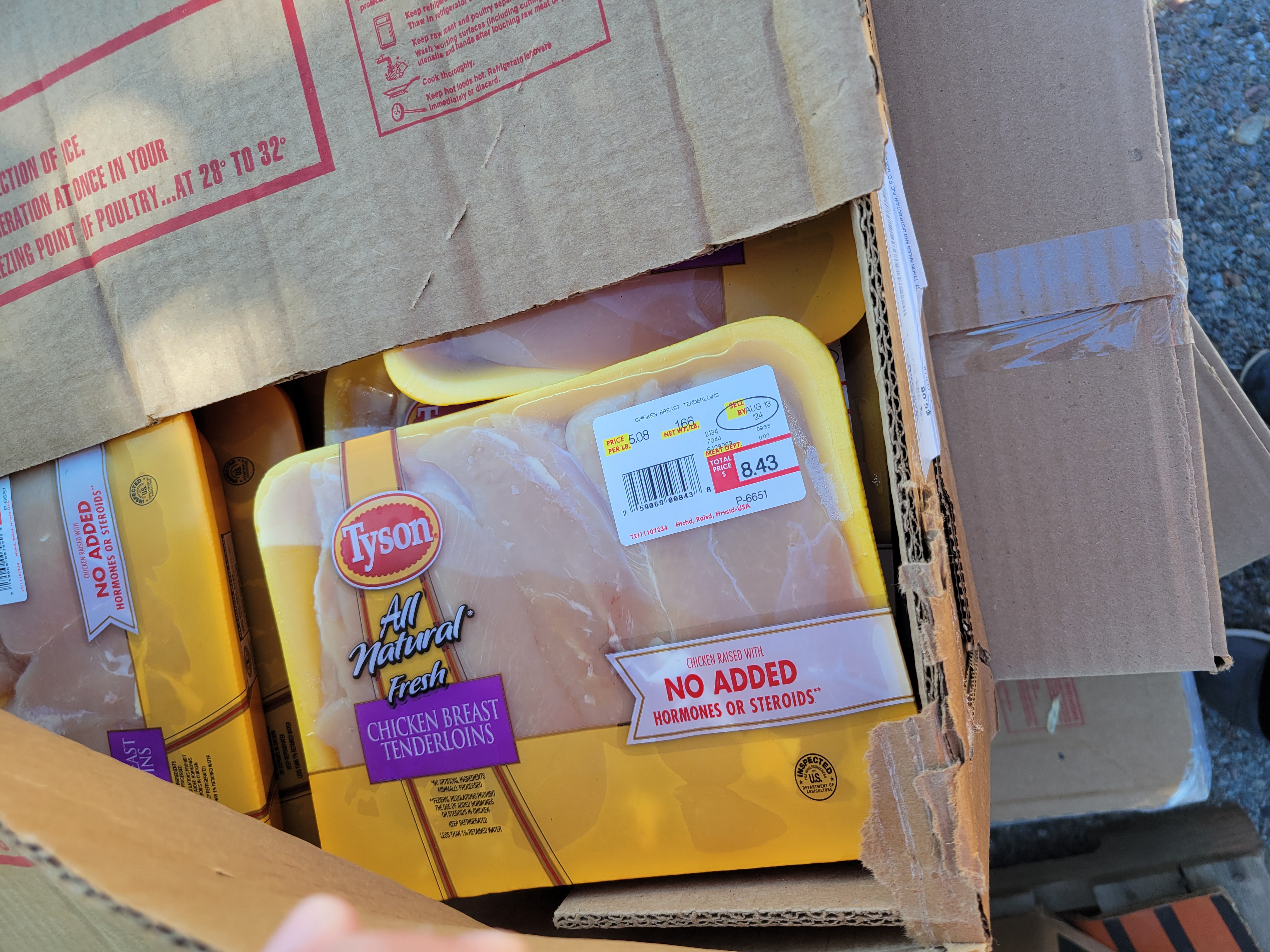 Open box showing frozen chicken breast tenderloins.